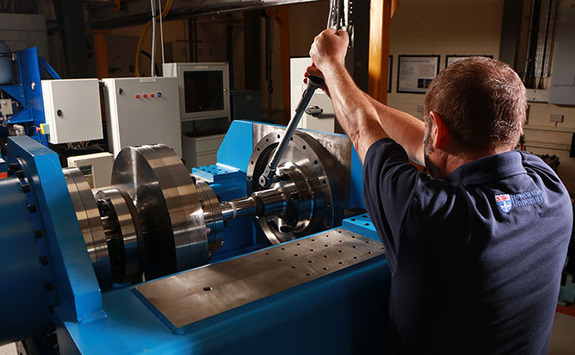 Someone using machinery in a workshop